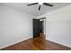 Bright bedroom with hardwood floors, white walls, a ceiling fan, and black doors at 1582 Pine Cir, Austell, GA 30168