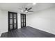 This bedroom offers a ceiling fan, dark wood floors, and two closets with paneled doors at 1582 Pine Cir, Austell, GA 30168