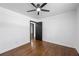 This bedroom features hardwood floors, ceiling fan, and black doors, offering a stylish and comfortable space at 1582 Pine Cir, Austell, GA 30168