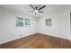 Bright bedroom features a modern ceiling fan, wood floors, and large windows at 1582 Pine Cir, Austell, GA 30168