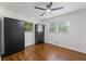 Bedroom with hardwood floors, two closets, a ceiling fan, and two windows overlooking the yard at 1582 Pine Cir, Austell, GA 30168