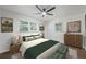 Relaxing bedroom with a ceiling fan, neutral tones, and scenic landscape art at 1582 Pine Cir, Austell, GA 30168