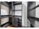 Walk-in closet features sleek black cabinetry, shelving, and drawers for ample storage at 1582 Pine Cir, Austell, GA 30168