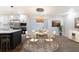 Charming dining area featuring a round table, modern chandelier, and seating for six, adjacent to the kitchen at 1582 Pine Cir, Austell, GA 30168