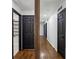 Bright hallway featuring hardwood floors, stylish doors, and sleek lighting at 1582 Pine Cir, Austell, GA 30168