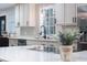 Modern kitchen features white countertops, stainless steel appliances, and sleek fixtures for a contemporary look at 1582 Pine Cir, Austell, GA 30168