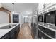 Modern kitchen featuring stainless steel appliances and a sleek black and white design with wood flooring at 1582 Pine Cir, Austell, GA 30168