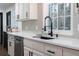 Bright kitchen features white cabinets, subway tile backsplash, black accents, and stainless steel appliances at 1582 Pine Cir, Austell, GA 30168