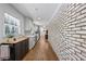 View of the kitchen with stainless appliances, white counters and exposed brick accent wall at 1582 Pine Cir, Austell, GA 30168