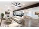 Bright living room featuring hardwood floors, a ceiling fan, and an open concept kitchen and dining area at 1582 Pine Cir, Austell, GA 30168