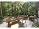 Inviting outdoor patio with dining and lounging, nestled amongst a beautiful wooded backyard at 1582 Pine Cir, Austell, GA 30168