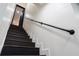 Elegant staircase featuring a black metal handrail and sleek, painted steps for a modern touch at 1582 Pine Cir, Austell, GA 30168