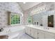 Bathroom with a soaking tub, double vanity, and abundant natural light from a large window at 1593 Poplarwood Lane Northwest Ln, Lawrenceville, GA 30043