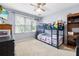 Cozy bedroom features a modern ceiling fan, bunk bed and bright window at 1593 Poplarwood Lane Northwest Ln, Lawrenceville, GA 30043