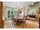 Formal dining room with a chandelier, large windows overlooking the yard, and wood table with seating for eight at 1593 Poplarwood Lane Northwest Ln, Lawrenceville, GA 30043