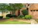 Inviting front exterior featuring brick accents, a well-maintained lawn, and mature landscaping at 1593 Poplarwood Lane Northwest Ln, Lawrenceville, GA 30043