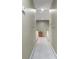 Well-lit hallway features neutral walls and leads to a charming display cabinet at the end of the hall at 1593 Poplarwood Lane Northwest Ln, Lawrenceville, GA 30043