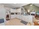 Kitchen with white cabinets, views to the living room, breakfast area, and the carpeted staircase at 1593 Poplarwood Lane Northwest Ln, Lawrenceville, GA 30043