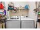 Functional laundry room features modern washer and dryer with convenient shelving at 1593 Poplarwood Lane Northwest Ln, Lawrenceville, GA 30043