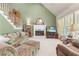 Comfortable living room with a fireplace, neutral carpet, and large windows for natural light at 1593 Poplarwood Lane Northwest Ln, Lawrenceville, GA 30043