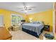 Bright main bedroom features a ceiling fan, large window, and comfortable bed at 1593 Poplarwood Lane Northwest Ln, Lawrenceville, GA 30043