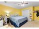 The main bedroom offers a bed, desk and is brightly lit with yellow walls at 1593 Poplarwood Lane Northwest Ln, Lawrenceville, GA 30043