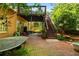 Brick patio under an elevated deck offers a charming outdoor space with stairs leading to the backyard at 1593 Poplarwood Lane Northwest Ln, Lawrenceville, GA 30043