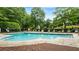 Beautiful community pool with several lounge chairs and plenty of surrounding trees at 1593 Poplarwood Lane Northwest Ln, Lawrenceville, GA 30043