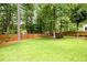 Large backyard features a lush, green lawn enclosed by a wooden fence and mature trees, offering a private outdoor space at 1596 Fearn Ne Cir, Brookhaven, GA 30319