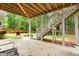 Backyard features a stone patio, stairs, a barbecue grill, and a grassy lawn with trees in the background at 1596 Fearn Ne Cir, Brookhaven, GA 30319