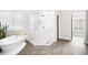 Bright bathroom featuring a soaking tub, walk-in glass shower, and plantation shutters at 1596 Fearn Ne Cir, Brookhaven, GA 30319