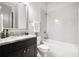 A clean bathroom with a white subway tile surround, a framed mirror and a granite countertop at 1596 Fearn Ne Cir, Brookhaven, GA 30319