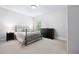 This spacious bedroom has neutral carpet and paint, as well as two bedside tables and a dresser at 1596 Fearn Ne Cir, Brookhaven, GA 30319