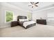 A spacious bedroom with a trey ceiling, neutral decor, and lots of natural light at 1596 Fearn Ne Cir, Brookhaven, GA 30319