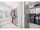 Organized walk-in closet with ample hanging space and natural light from a nearby window at 1596 Fearn Ne Cir, Brookhaven, GA 30319