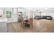 Open-concept living room and dining area with hardwood floors, stainless steel appliances, and a gray sofa at 1596 Fearn Ne Cir, Brookhaven, GA 30319