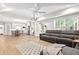 Open-concept living room with vaulted ceilings, abundant natural light, a ceiling fan, and hardwood floors at 1596 Fearn Ne Cir, Brookhaven, GA 30319