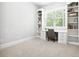 Bright office space with built-in bookshelves, a large window, and a work area at 1596 Fearn Ne Cir, Brookhaven, GA 30319