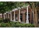 Exterior of a brick retail building featuring white columns, black framed windows and doors, and professionally landscaped grounds at 1596 Fearn Ne Cir, Brookhaven, GA 30319