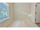 Bedroom features neutral carpet, natural light, and white trim at 2587 Ocean Walk Nw Dr, Atlanta, GA 30318