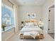 Tranquil bedroom with large window, soft bedding, and minimalist decor provides a serene and comfortable retreat at 2587 Ocean Walk Nw Dr, Atlanta, GA 30318