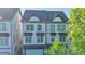 Stately exterior showcases classic architecture with multiple windows that let in ample light and a garage for convenient parking at 2587 Ocean Walk Nw Dr, Atlanta, GA 30318