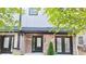 Charming brick home with a black trimmed front door and manicured landscaping at 2587 Ocean Walk Nw Dr, Atlanta, GA 30318