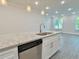 Kitchen island featuring seating, granite counters, stainless steel dishwasher at 2587 Ocean Walk Nw Dr, Atlanta, GA 30318