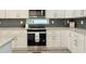 Updated kitchen featuring a stainless steel range, white cabinets and granite countertops at 2587 Ocean Walk Nw Dr, Atlanta, GA 30318