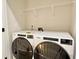 Laundry room with side-by-side washer and dryer and wire shelving at 2587 Ocean Walk Nw Dr, Atlanta, GA 30318