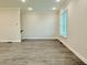 Bright living room featuring hardwood floors, recessed lighting, and large window for natural light at 2587 Ocean Walk Nw Dr, Atlanta, GA 30318