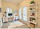 Bright office space with a well-lit desk, French doors, and organized shelving fosters productivity and comfort at 2587 Ocean Walk Nw Dr, Atlanta, GA 30318