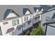 Charming townhomes with modern architectural details and dark rooflines create a cohesive and appealing street view at 2587 Ocean Walk Nw Dr, Atlanta, GA 30318