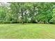 Expansive backyard with mature trees at 3799 Sweetbriar Cir, Lithia Springs, GA 30122